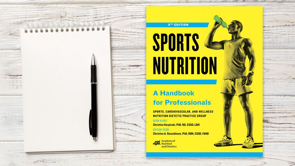 Copy of Sports Nutrition: A Handbook for Professionals, 6th Ed. lying on a desk.