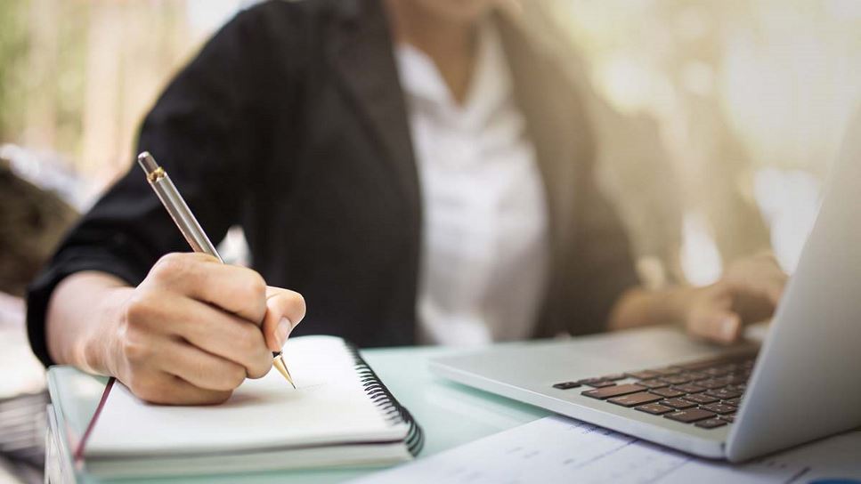 image of a practitioner studying online and taking notes