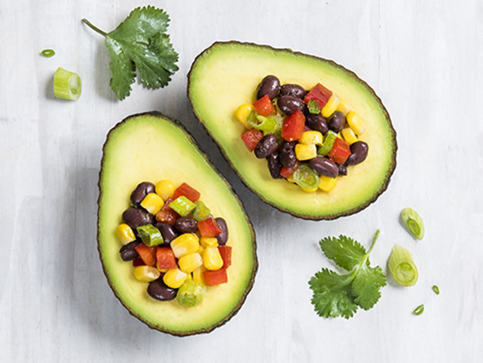 half an avocado stuffed with diced tomato and cilantro
