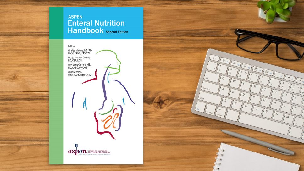 Copy of ASPEN Enteral Nutrition Handbook, 2nd Ed. lying on a desk.