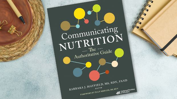 Copy of Communicating Nutrition: The Authoritative Guide lying on a desk.