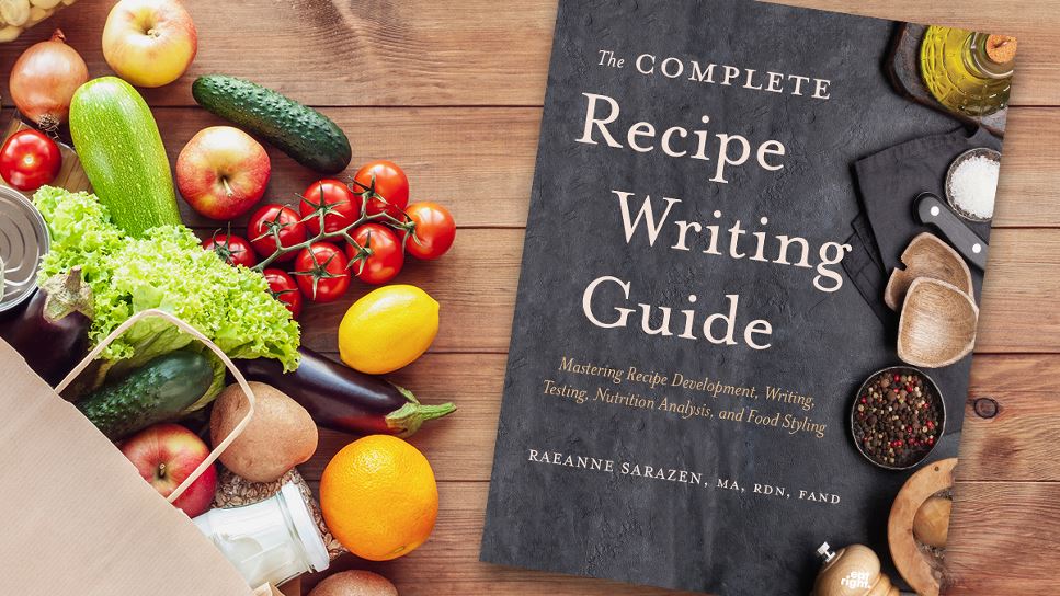 Copy of The Complete Recipe Writing Guide: Mastering Recipe Development, Writing, Testing, Nutrition Analysis and Food Styling lying on a desk.