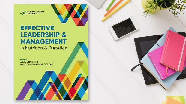 Copy of Effective Leadership & Management in Nutrition & Dietetics lying on a desk.