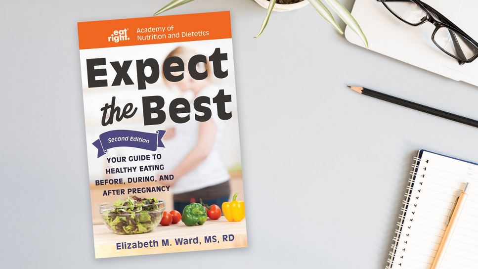 Copy of Expect the Best: Your Guide to Healthy Eating Before, During, and After Pregnancy, 2nd Ed. lying on a desk.
