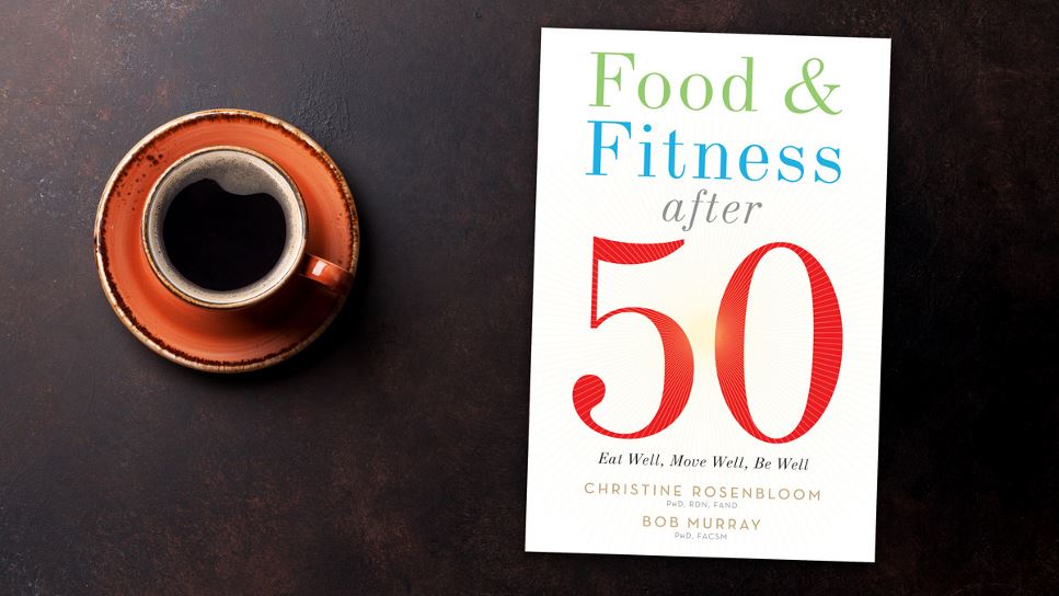 Copy of Food & Fitness After 50: Eat Well, Move Well, Be Well lying on a desk.