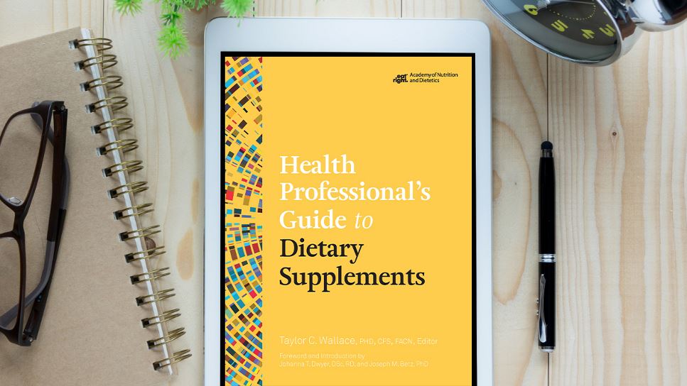 Health Professional's Guide to Dietary Supplements on a tablet screen, with the tablet lying on a desk.