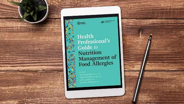 Health Professional's Guide to Nutrition Management of Food Allergies on a tablet screen, with the tablet lying on a desk.