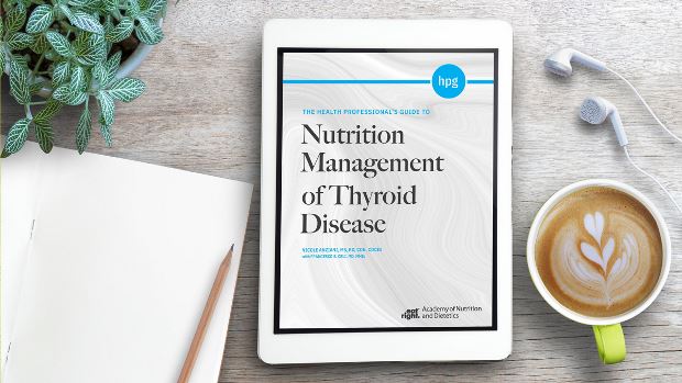Health Professional's Guide to Nutrition Management of Thyroid Disease on a tablet screen, with the tablet lying on a desk.
