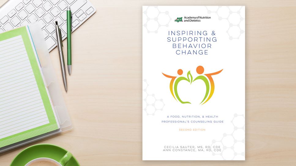 Copy of Inspiring and Supporting Behavior Change: A Food, Nutrition, and Health Professional's Counseling Guide, 2nd Ed. lying on a desk.