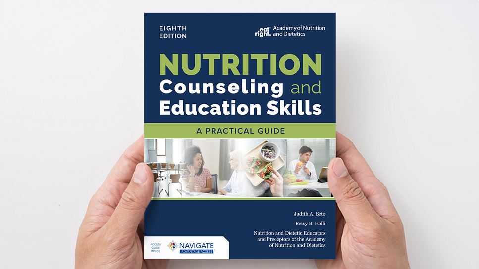 Copy of Nutrition Counseling and Education Skills: A Practical Guide, 8th Ed. lying on a desk.
