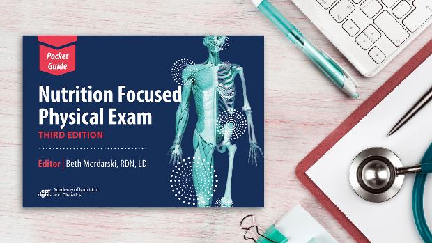 Copy of Nutrition Focused Physical Exam Pocket Guide, 3rd Ed. lying on a desk.