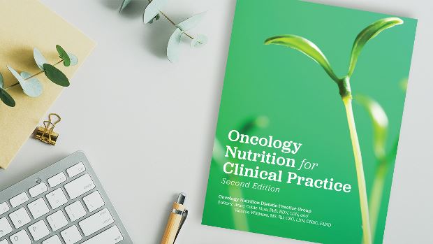 Copy of Oncology Nutrition for Clinical Practice, 2nd Ed. lying on a desk.