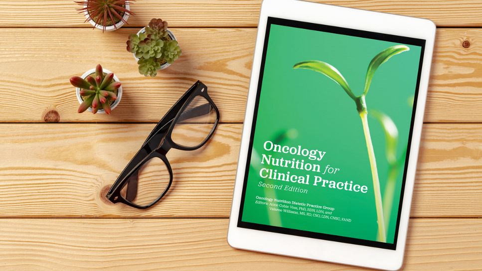 Oncology Nutrition for Clinical Practice, 2nd Ed. on a tablet screen, with the tablet lying on a desk.