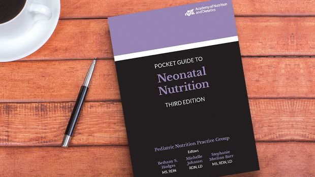 Copy of Pocket Guide to Neonatal Nutrition, 3rd Ed. lying on a desk.