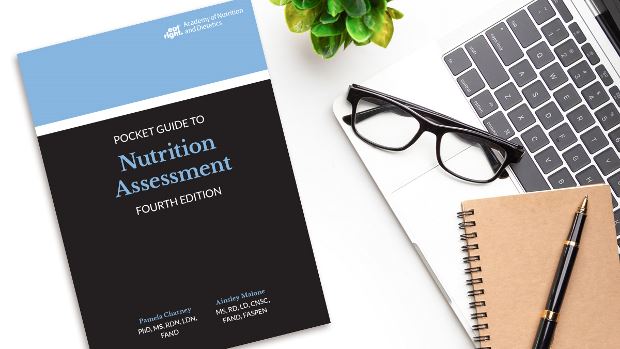 Copy of Pocket Guide to Nutrition Assessment, 4th Ed. lying on a desk.