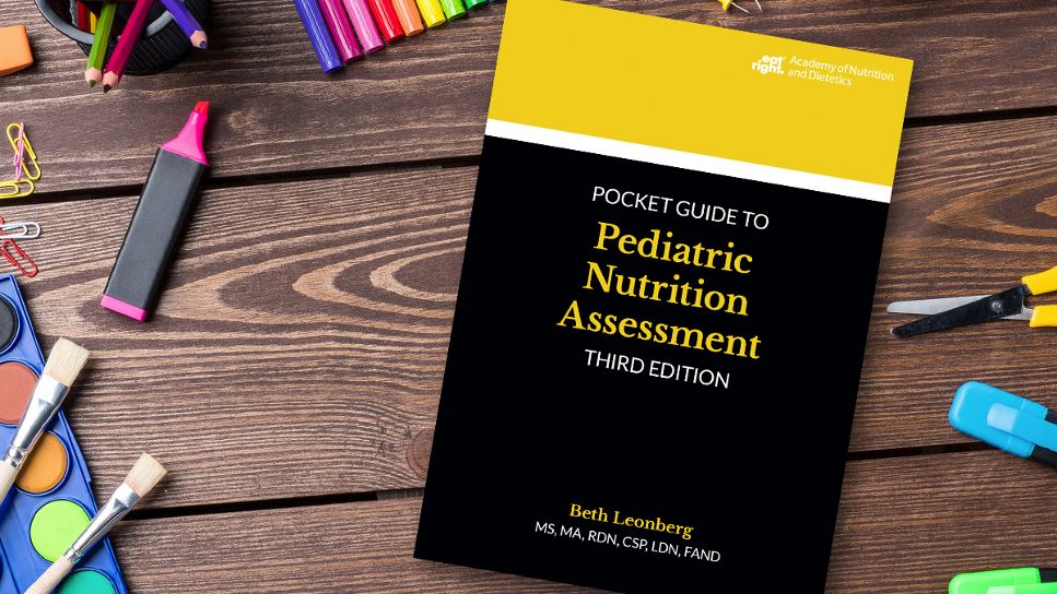 Copy of Pocket Guide to Pediatric Nutrition Assessment, 3rd Ed. lying on a desk.