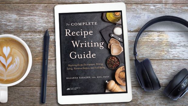 The Complete Recipe Writing Guide: Mastering Recipe Development, Writing, Testing, Nutrition Analysis and Food Styling for Photos and Videos on a tablet screen, with the tablet lying on a desk.
